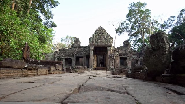 4K, Entrance door to Preah Khan temple. Gate with one guard sculpture. Ancient monument ruins in Angkor Thom Cambodia. Religious architecture landmarks buildings near Siem Reap. Khmer empire. -Dan