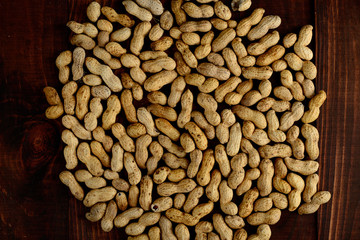 Peanuts on a dark background. Peanuts in the shell. Healthy food.