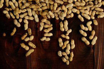 Peanuts on a dark background. Peanuts in the shell. Healthy food.