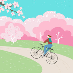 Park landscape with cherry blossom and girl on a bicycle.