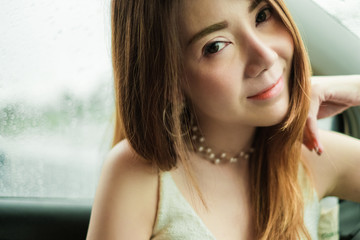 Portrait beautiful asian woman in car. Looking at camera. selective focus