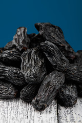 black raisins on white the wooden background