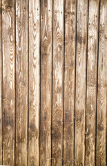 The background of old planed boards is brown with a pronounced wood structure, texture design.