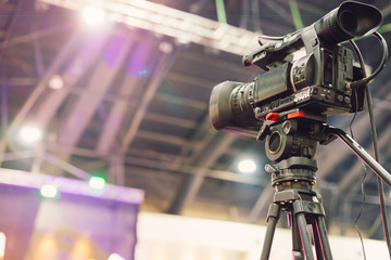 Video camera taking live video streaming with people working background at meeting room. Selective...