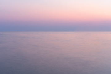 Fototapeta na wymiar Sunset into the sea with twilight sky