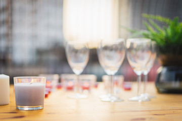 Candles in small little glasses, romantic dinner setting with wedding day concepts.