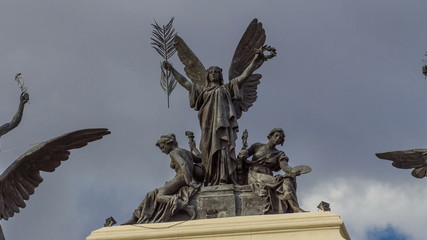 Statue on the top of beautiful government palace facade the Ministry of Agriculture building timelapse hyperlapse is placed close to the Atocha railway station in Madrid, Spain.