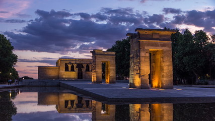 Sunset over the Templo de debod timelapse. The Temple of Debod is an ancient Egyptian temple which was rebuilt in Madrid, Spain. - obrazy, fototapety, plakaty