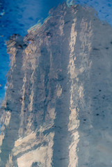 Abstract reflection in water puddle on cobblestone street of Notre-Dame de Strasbourg Cathedral of Our Lady of Strasbourg in central Strasbourg
