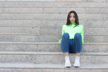 Attractive and fashionablecaucasian young woman with ideal slim sexy body wearing longsleave shirt...