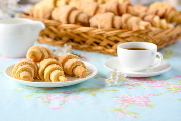 Three croissants on a table with spring flowers