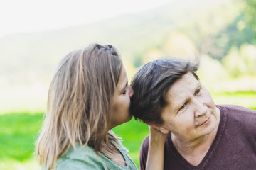Two women smelling hair each other