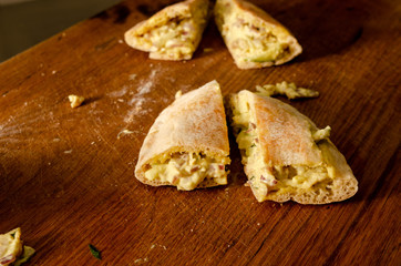 Cypriot pie chicken sauce with green apple on wood background