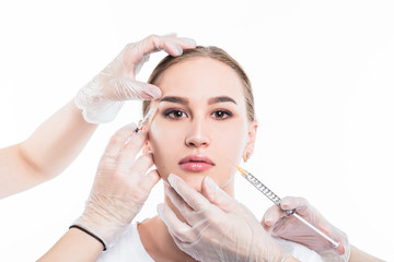 Beautician makes an injection to a beautiful, young girl.