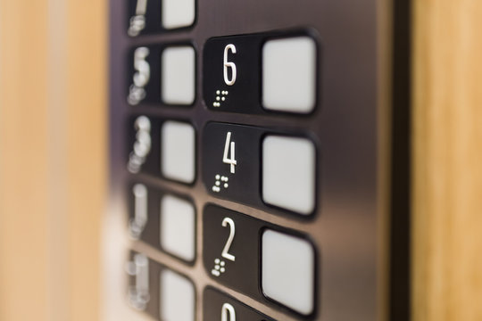 Close up of elevator control panel buttons.