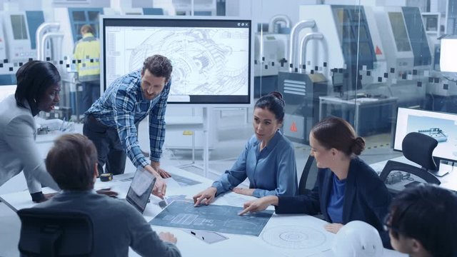 Modern Factory Office Meeting Room: Busy Diverse Team of Engineers, Managers and Investors Talking at Conference Table, Use Interactive TV, Analyze, Find Solutions, Debate and Discuss Engine Concept