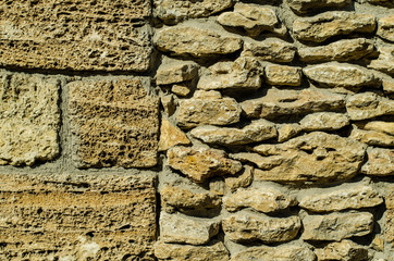 Stone wall. The wall is made of stone. The wall is made of bricks. The structure of the stone.