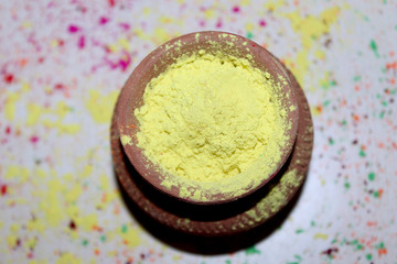 Traditional color celebration, Bright colors in clay pot for Indian Holi Festival, Organic Gulal colors pattern.
