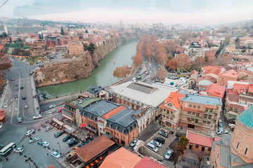 Fototapeta na wymiar Tbilisi, Georgia, 15 December 2019 - aerial view of the old city from the cab of the funicular, shot through glass