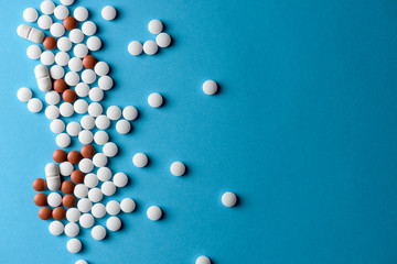 Mixture of multiple types of drugs scattered on a blue background