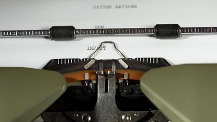 IMPACT, SDG and UNITED NATIONS written on old green vintage retro typewriter the 17 UN sustainable developement goals with sound