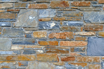 wall of uneven rocky stones on the houses of the pelion mountain