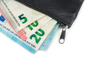 Euro and coins in a shabby wallet. Poverty concept