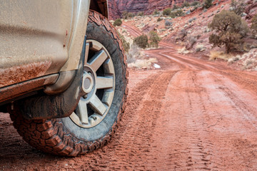 4x4 SUV car or truck driving on a dirt canyon road