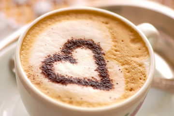 cup of strong coffee cappuccino with milk foam and heart of cinnamon