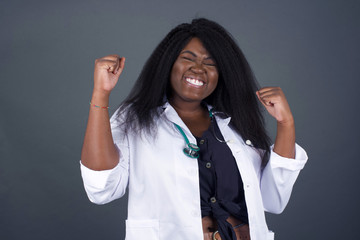 Caucasian brunette woman rejoicing her success and victory clenching her fists with joy. Lucky woman being happy to achieve her aim and goals. Positive emotions, feelings.