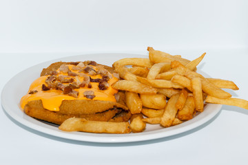 Argentinian food. Milanesa with bacon and cheese with french fries