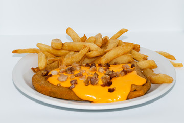 Argentinian food. Milanesa with bacon and cheese with french fries