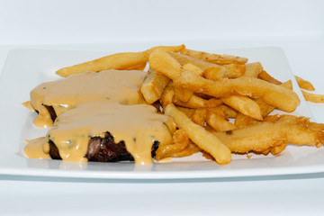 Argentinian food. Milanesa with bacon and cheese with french fries