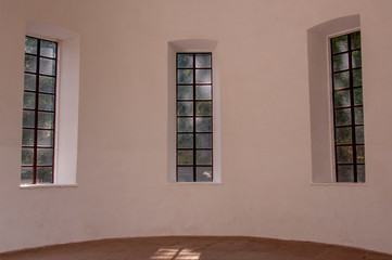 Ancient long glass three windows on the light wall 