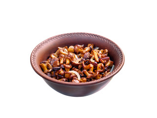 Fried chanterelles with onion in rustic bowl isolated on white background