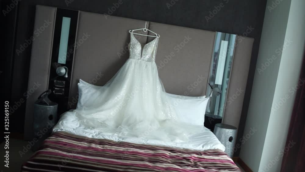 Poster wedding dress hanging on the wall