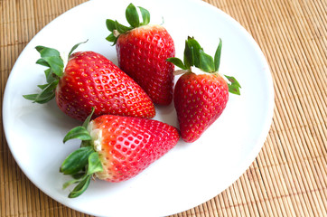 Fresh strawberries in a white plate