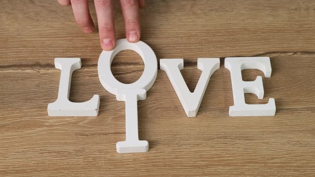 Letters word Live change on Love. Close up.