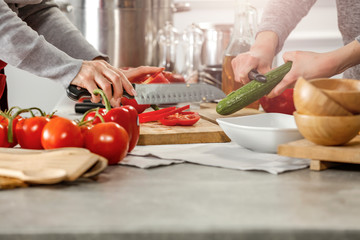 Hands in kitchen making meal.Table of free space for your decoration and fresh vegetables. 