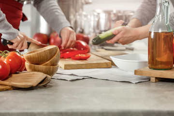 Hands in kitchen making meal.Table of free space for your decoration and fresh vegetables. 