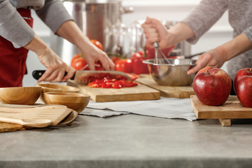 Hands in kitchen making meal.Table of free space for your decoration and fresh vegetables. 