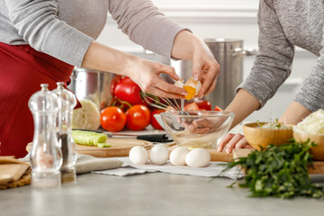 Hands in kitchen making meal.Table of free space for your decoration and fresh vegetables. 