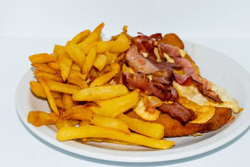 Argentinian food. Milanesa with bacon and cheese with french fries
