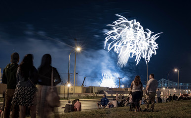 Obraz premium people watching fireworks. Jacques Cartier bridge with fireworks. Montreal Fireworks.