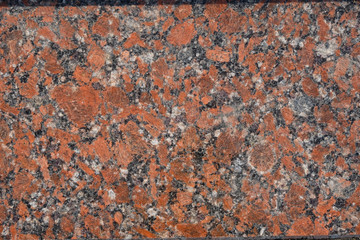 Granite surface in orange, gray, white, black mix. Copy space. Minimalism. 
