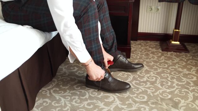 man puts on shoes