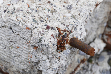 rotten concrete and iron, materials that are not earthquake resistant,