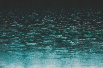 Rain droplets hitting water