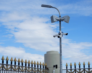 CCTV cameras and loudspeakers are mounted on a pole to ensure the security of private property