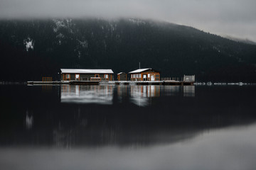 Soft morning reflection of house on a lake